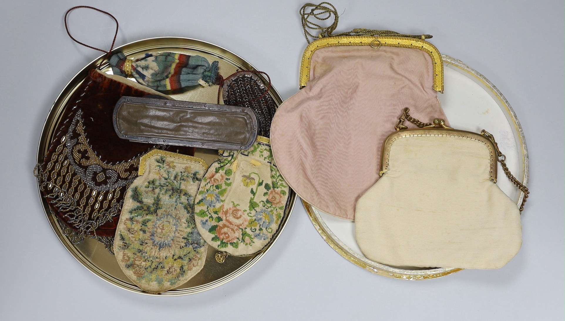 A Victorian cut steel leather and ribbon worked ladies spectacle case and a pair of spectacles, two similar silk embroidered bags, a velvet and cut steel bag and four various purses (9)